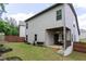 Expansive backyard with covered patio, garden planters, wooden fence, and lush green lawn at 103 Prominence Ct, Canton, GA 30114