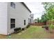 Side view of the property's backyard with garden boxes, wooden fencing, and landscaping at 103 Prominence Ct, Canton, GA 30114