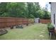 Spacious backyard featuring a storage shed, garden beds, and a wooden fence at 103 Prominence Ct, Canton, GA 30114