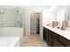 Bathroom features a tub, glass shower, and sleek vanity with modern fixtures, creating a spa-like experience at 103 Prominence Ct, Canton, GA 30114