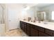 Modern bathroom with double vanity, large mirror, and ample storage, complemented by a relaxing bathtub at 103 Prominence Ct, Canton, GA 30114