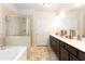 Bright bathroom with double vanity, soaking tub, and separate shower, offering a spa-like experience at 103 Prominence Ct, Canton, GA 30114