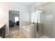 Bright bathroom features a shower, soaking tub, and tile flooring, offering a relaxing and functional space at 103 Prominence Ct, Canton, GA 30114