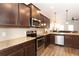 Modern kitchen with dark cabinets, stainless steel appliances, and granite countertops at 103 Prominence Ct, Canton, GA 30114