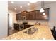 Open-concept kitchen featuring granite countertops and a double sink at 103 Prominence Ct, Canton, GA 30114