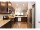 Well-appointed kitchen with stainless steel appliances and dark wood cabinets at 103 Prominence Ct, Canton, GA 30114