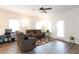 Bright living room with gray wood floors, ceiling fan, and comfortable seating near natural light at 103 Prominence Ct, Canton, GA 30114