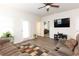A cozy living room offers an open floor plan, modern gray floors, and comfortable seating at 103 Prominence Ct, Canton, GA 30114