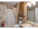 Cozy bathroom with decorative wood backsplash, curtained bathtub, and a single vanity at 1104 Stepping Stone Ln, Conyers, GA 30012