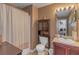 Well-lit bathroom featuring a shower, vanity, toilet, and washer/dryer area at 1104 Stepping Stone Ln, Conyers, GA 30012