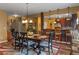 Open dining room featuring hardwood floors, decorative lighting, and open kitchen area at 1104 Stepping Stone Ln, Conyers, GA 30012