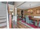 Elegant dining room with chandelier, hardwood floors, and staircase view at 1104 Stepping Stone Ln, Conyers, GA 30012