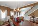 Dining room featuring a chandelier, hardwood floors, and staircase view at 1104 Stepping Stone Ln, Conyers, GA 30012