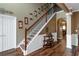 Inviting foyer featuring a staircase with wooden banister and decorative wall accents at 1104 Stepping Stone Ln, Conyers, GA 30012