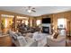 Spacious living room with a fireplace, ceiling fan, and open floor plan to kitchen at 1104 Stepping Stone Ln, Conyers, GA 30012