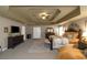 Large main bedroom featuring dark wood furniture, tray ceilings and decorative wall art at 1104 Stepping Stone Ln, Conyers, GA 30012