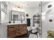 Modern bathroom with double sink vanity, large mirror, and glass enclosed shower with black hardware at 2382 Whites Mill Ln, Decatur, GA 30032