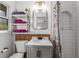 Small bathroom with storage shelves, bright lighting, and white subway tile shower at 2382 Whites Mill Ln, Decatur, GA 30032