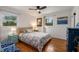 Comfortable bedroom with hardwood floors, two windows, and soft lighting from bedside table lamps at 2382 Whites Mill Ln, Decatur, GA 30032