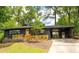 Charming home featuring a black brick exterior, wooden details, and a well-manicured front yard at 2382 Whites Mill Ln, Decatur, GA 30032