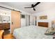Cozy main bedroom with barn door access to ensuite bath, ceiling fan, and hardwood floors at 2382 Whites Mill Ln, Decatur, GA 30032