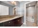 Bathroom showcasing granite counters, dark cabinetry, and shower and tub perfect for relaxation at 905 Ju Ne Street Ne St, Atlanta, GA 30309