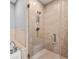 Elegant bathroom featuring a glass-enclosed shower with beige tile, and modern fixtures at 905 Ju Ne Street Ne St, Atlanta, GA 30309