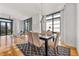 Dining room with large windows, hardwood floors, and a modern light fixture at 905 Ju Ne Street Ne St, Atlanta, GA 30309