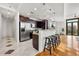 Modern kitchen with stainless steel appliances, dark wood cabinets, and a breakfast bar at 905 Ju Ne Street Ne St, Atlanta, GA 30309