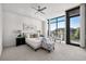 Bright main bedroom featuring large windows with neighborhood views at 905 Ju Ne Street Ne St, Atlanta, GA 30309