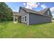 A beautiful view of backyard with lush greenery, showcasing a home's exterior with elegant gray siding at 109 Sunflower Ne Cir, Cartersville, GA 30121