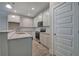Kitchen with white cabinetry, granite countertops, stainless appliances, and grey wood floors at 109 Sunflower Ne Cir, Cartersville, GA 30121