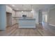 Kitchen with white cabinets, granite countertops, stainless appliances, and grey wood floors at 109 Sunflower Ne Cir, Cartersville, GA 30121