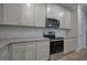 White kitchen featuring granite countertops, stainless appliances, and modern finishes at 109 Sunflower Ne Cir, Cartersville, GA 30121