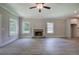 Inviting living room featuring a stone fireplace, wood floors, and modern ceiling fan at 109 Sunflower Ne Cir, Cartersville, GA 30121