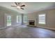 Bright living room featuring wood floors, a stone fireplace, ceiling fan, and outdoor access at 109 Sunflower Ne Cir, Cartersville, GA 30121