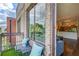 Balcony view showcasing outdoor seating, a glimpse of the interior, and views of the surrounding trees and neighborhood at 1418 Dresden Ne Dr # 385, Brookhaven, GA 30319