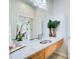 Bathroom vanity with dual sinks, granite countertop, and decorative plants at 1418 Dresden Ne Dr # 385, Brookhaven, GA 30319