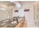 Elegant bathroom featuring double sinks, granite countertop, and glass-enclosed shower at 1418 Dresden Ne Dr # 385, Brookhaven, GA 30319