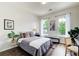 Cozy bedroom with a queen bed, natural light, and hardwood floors at 1418 Dresden Ne Dr # 385, Brookhaven, GA 30319