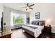 Cozy bedroom with ceiling fan, a plush bed, and scenic window view at 1418 Dresden Ne Dr # 385, Brookhaven, GA 30319