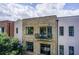 Brick townhome with multiple stories and windows, featuring a cozy balcony with seating overlooking the neighborhood at 1418 Dresden Ne Dr # 385, Brookhaven, GA 30319
