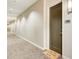 Well-lit hallway with patterned carpet, leading to unit with 'all are welcome here' doormat, creating a warm ambiance at 1418 Dresden Ne Dr # 385, Brookhaven, GA 30319