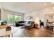 Cozy living room with large windows, sectional couch, and hardwood floors at 1418 Dresden Ne Dr # 385, Brookhaven, GA 30319