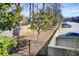 Community parking area adjacent to fenced green space with young trees, enhancing property's outdoor appeal at 1418 Dresden Ne Dr # 385, Brookhaven, GA 30319