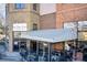 Commercial building featuring brick facade, outdoor seating beneath an awning, and signage for 'The One Sushi Kitchen Bar' at 1418 Dresden Ne Dr # 385, Brookhaven, GA 30319