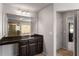 Bathroom with dark vanity and large framed mirror at 1520 Gallant Fox Ln, Suwanee, GA 30024