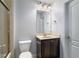 Bathroom featuring a vanity with dark cabinets and framed mirror at 1520 Gallant Fox Ln, Suwanee, GA 30024