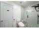 Modern bathroom featuring a sleek glass shower with gray tile and a toilet with smart features at 1520 Gallant Fox Ln, Suwanee, GA 30024