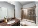 Updated bathroom features granite countertop, tile shower, and modern fixtures at 1520 Gallant Fox Ln, Suwanee, GA 30024